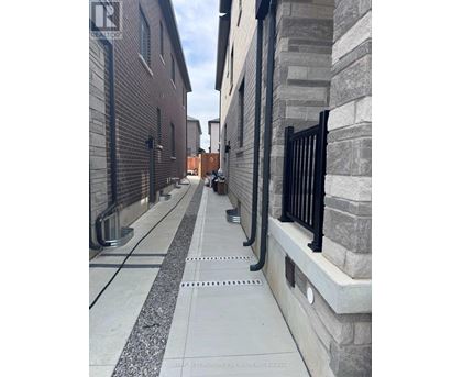 A long concrete walkway with a metal railing on the right side.