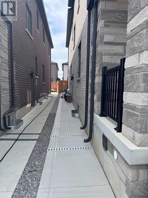 A long concrete walkway with a metal railing on the right side.