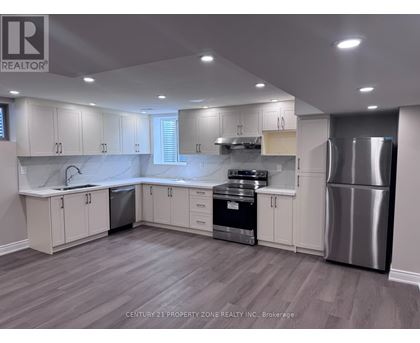 A kitchen with white cabinets and stainless steel appliances.