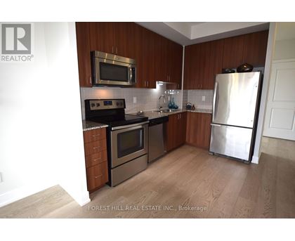 A kitchen with wooden cabinets and stainless steel appliances.