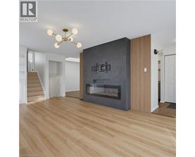 A modern living room with a fireplace and wooden floors.