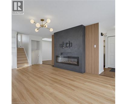 A modern living room with a fireplace and wooden floors.