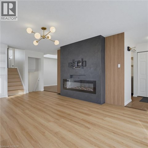 A modern living room with a fireplace and wooden floors.