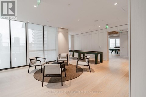 A modern office space with a glass wall and a view of the city.