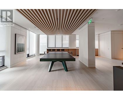 A modern room with a long table and a green bench.