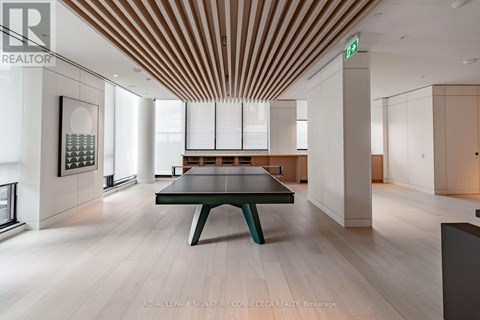 A modern room with a long table and a green bench.