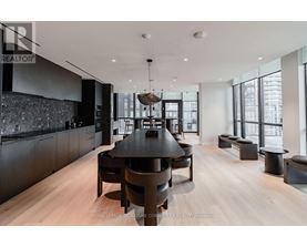 A modern dining room with a large table and chairs.