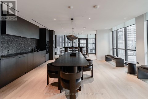 A modern dining room with a large table and chairs.
