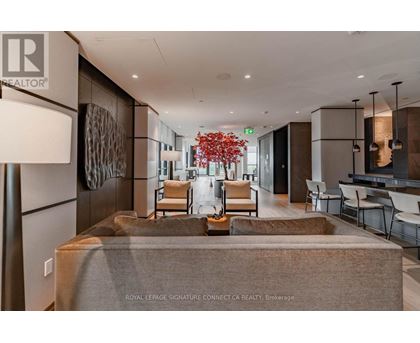 A living room with a couch and chairs with a sign that says REALTOR.