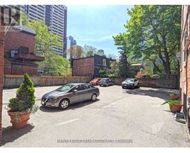 A parking lot with cars and a building in the background.