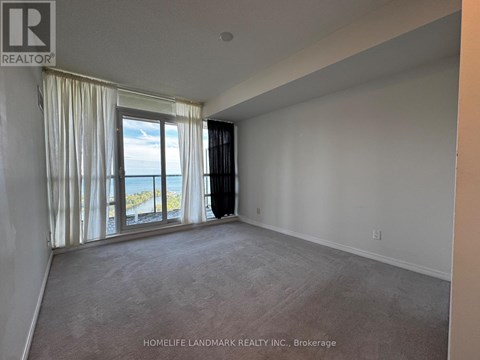 A room with a large window overlooking the ocean.