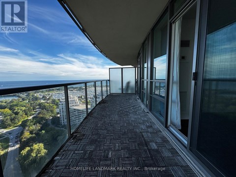 A balcony with a view of the city and trees.