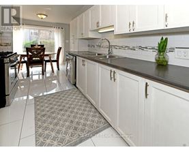 A kitchen with white cabinets and a black countertop.