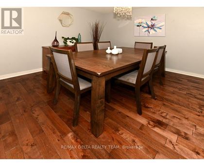 A dining room with a wooden table and chairs.