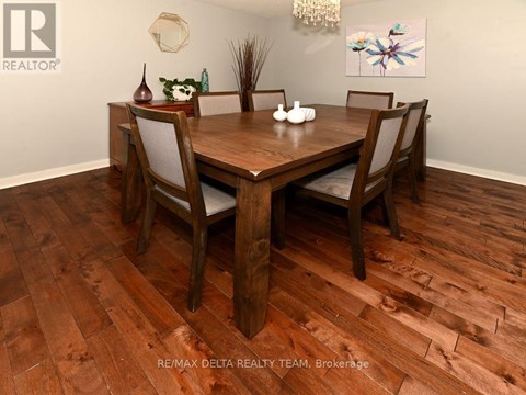 A dining room with a wooden table and chairs.