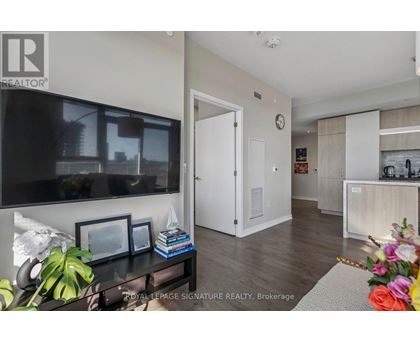 A living room with a flat screen TV and a white door.