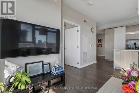 A living room with a flat screen TV and a white door.