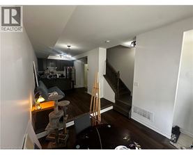 A room with a staircase and a cat tree.