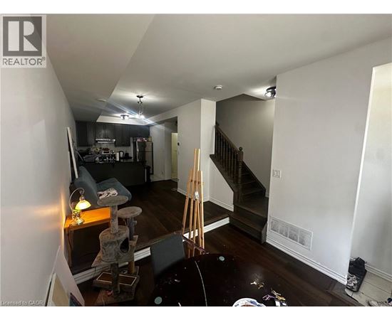 A room with a staircase and a cat tree.
