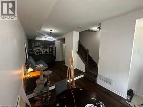 A room with a staircase and a cat tree.