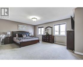 A bedroom with a bed, dresser, and mirror.