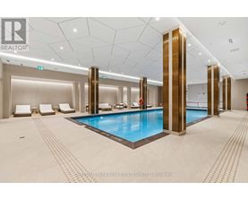 A large indoor swimming pool with a tiled floor and a tiled wall.