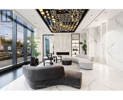 A modern living room with a grey sofa and a marble floor.