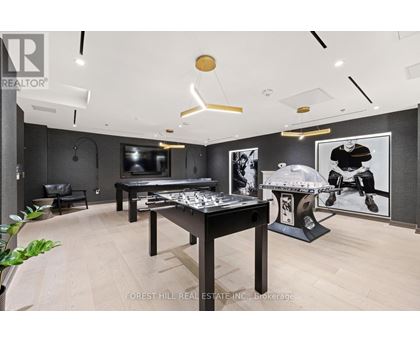 A room with a pool table and a foosball table.