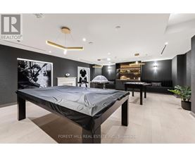 A bedroom with a large bed and a couch.