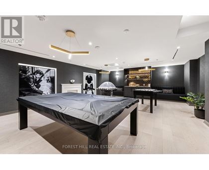A bedroom with a large bed and a couch.