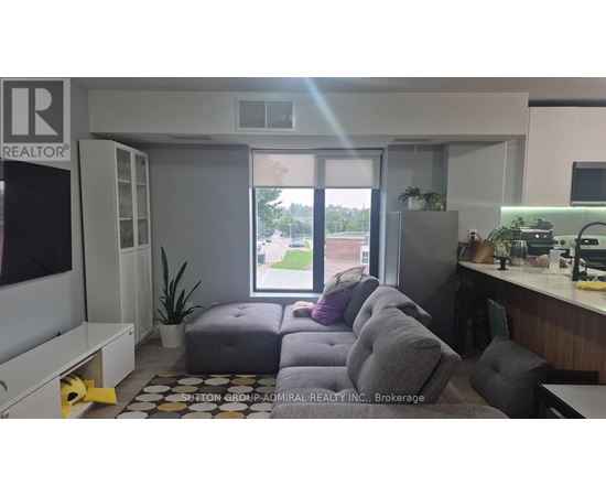 A realtor's office with a couch and a window showing an outdoor view.
