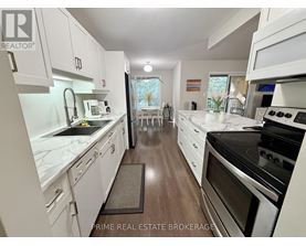A kitchen with white cabinets and a black stove top oven.