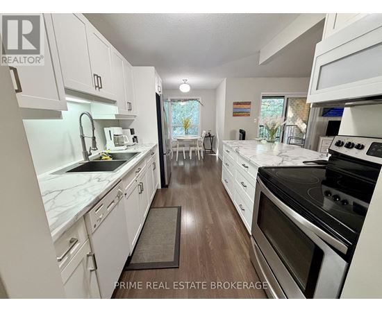 A kitchen with white cabinets and a black stove top oven.