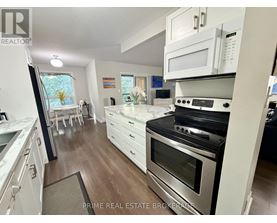 A kitchen with white cabinets and a black oven.