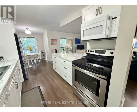 A kitchen with white cabinets and a black oven.