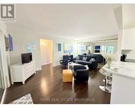 A living room with a white entertainment center and a white sofa.