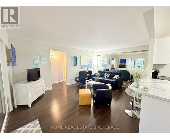 A living room with a white entertainment center and a white sofa.