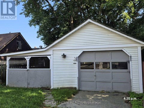 A garage with a white exterior and a grey door is shown.