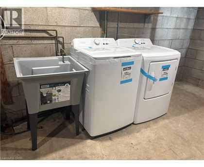A washing machine and a sink are in a room.