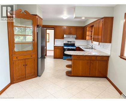 A kitchen with wooden cabinets and a refrigerator.