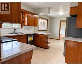 A kitchen with wooden cabinets and a granite countertop.