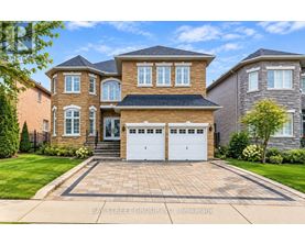 A large, two-story house with a brick facade and a white garage door.