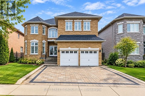 A large, two-story house with a brick facade and a white garage door.