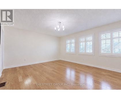 A room with wooden flooring and white walls.