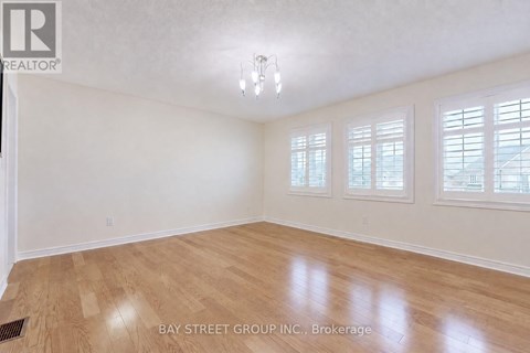 A room with wooden flooring and white walls.