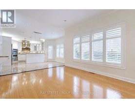 A spacious living room with wooden floors and white walls.