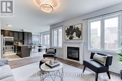 A living room with a fireplace and a painting on the wall.