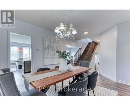 A dining room with a wooden table and chairs.