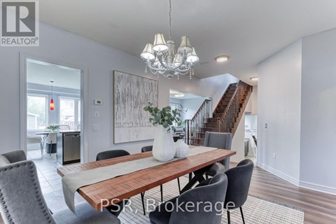A dining room with a wooden table and chairs.