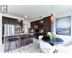 A modern kitchen with a bar area and a dining table set up.